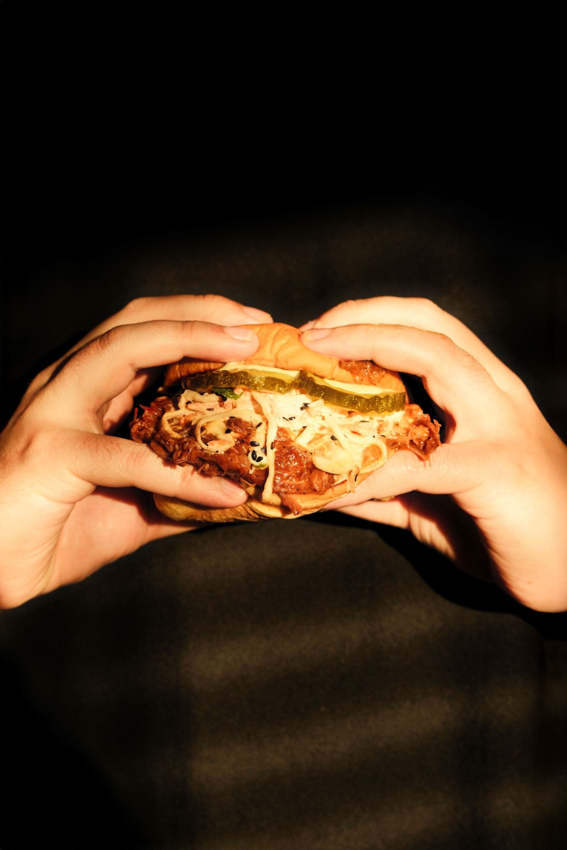 The Fried Chicken Sando, held in two hands